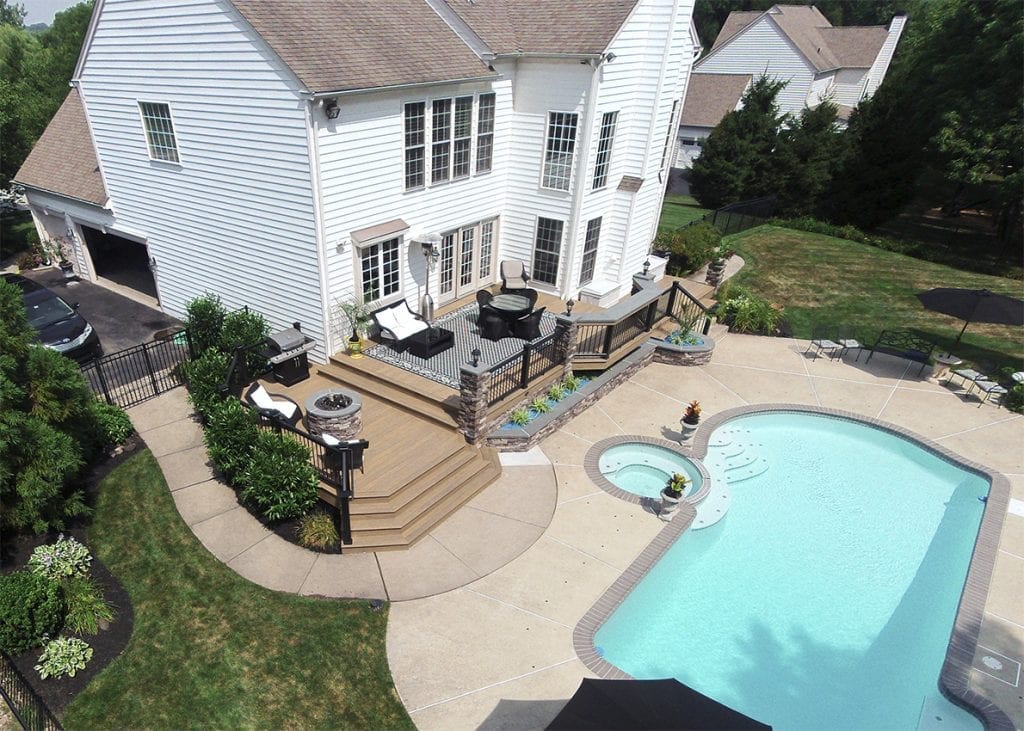 inground pool with curved deck and patio deck and patio with matching curve