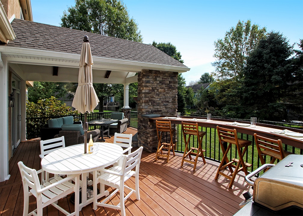 deck with bar seating near the grill and cooking space custom deck with grill space and bar seating