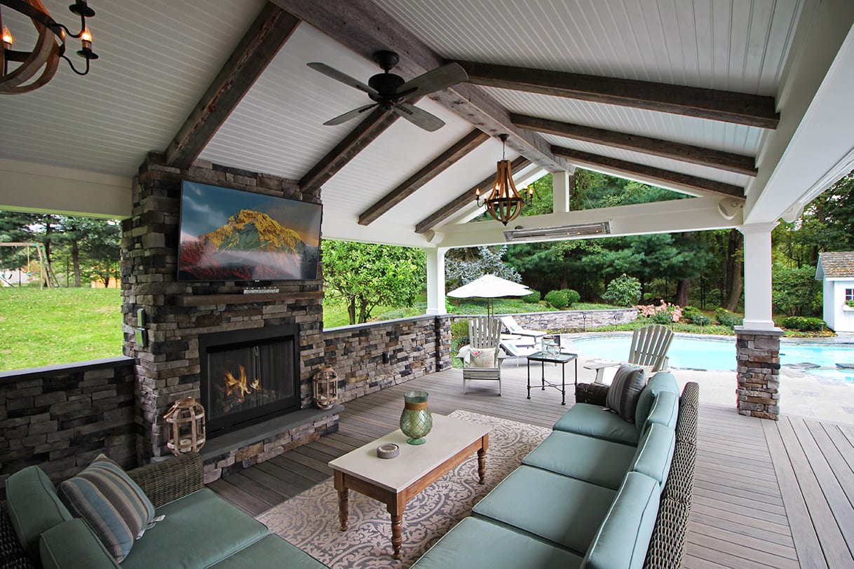 back porch design with barnwood ceiling and stonework fireplace covered porch with fireplace and ceiling fan
