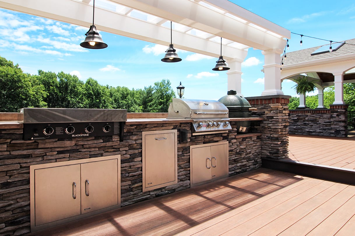 outdoor kitchen with a built in grill, green egg and flat top griddle full outdoor kitchen