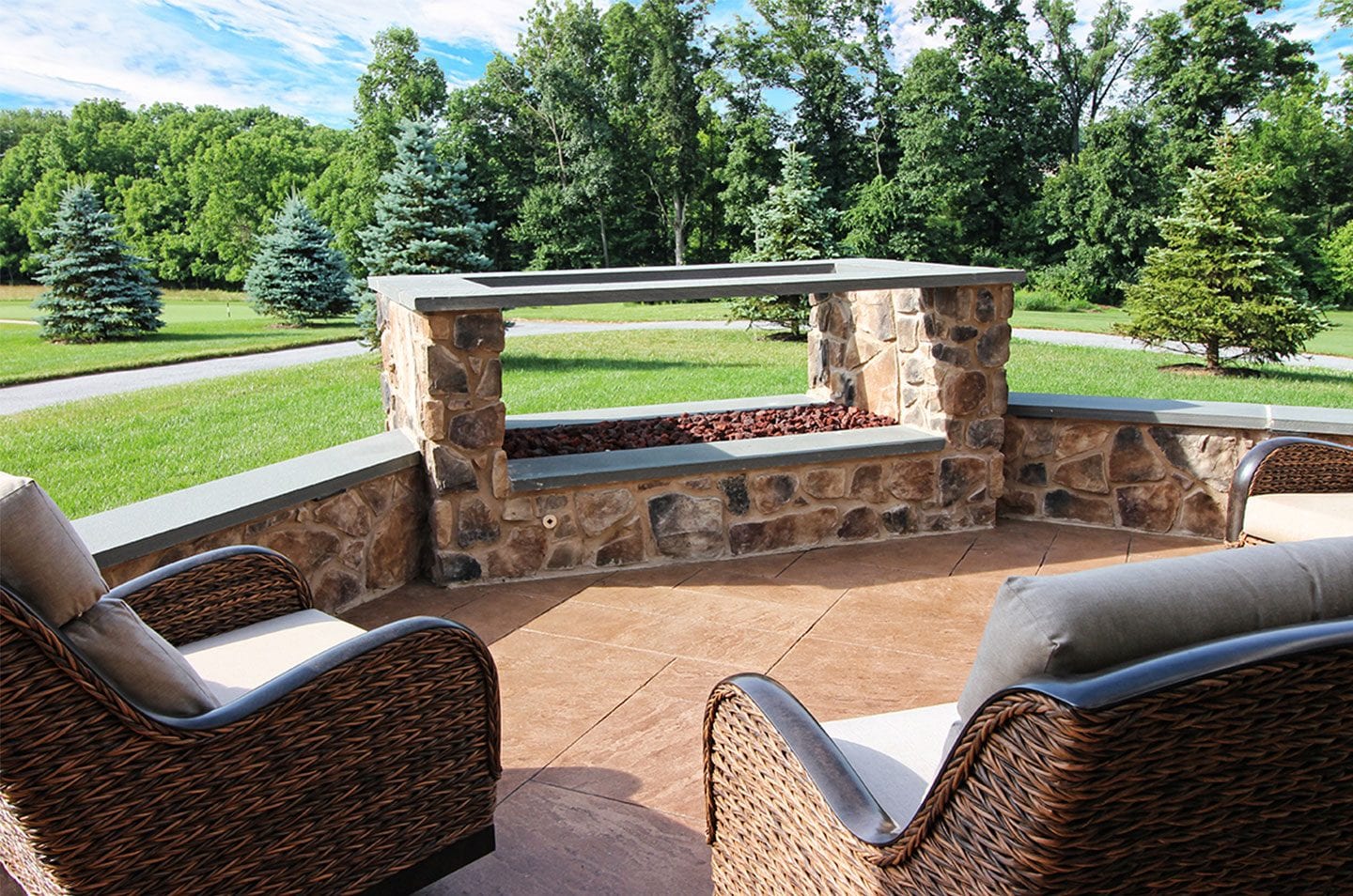 fireplace deck add-on done in Fieldstone veneer linear fire feature deck add-on